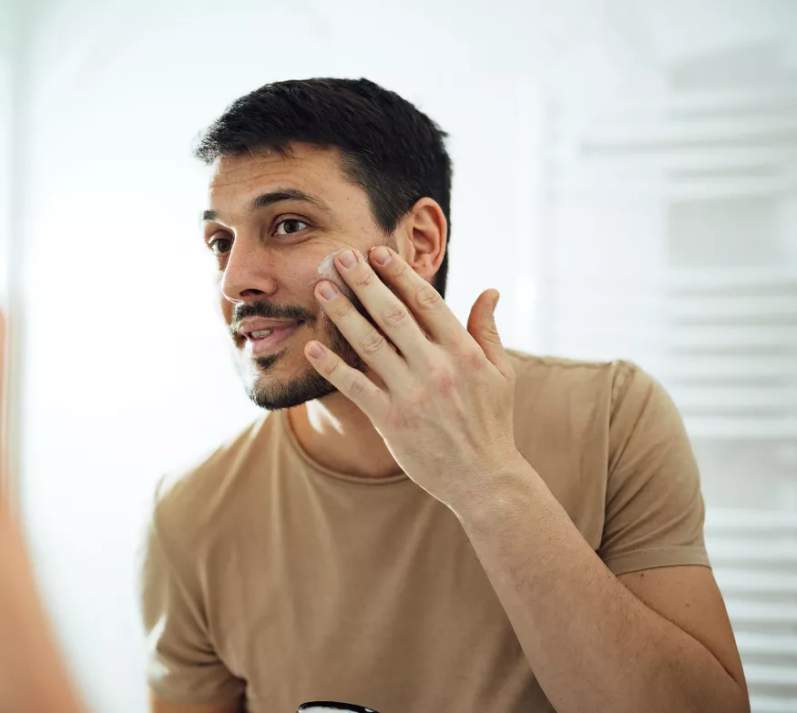 Mann påfører Herbal Aloe Pleiende Gel i ansiktet